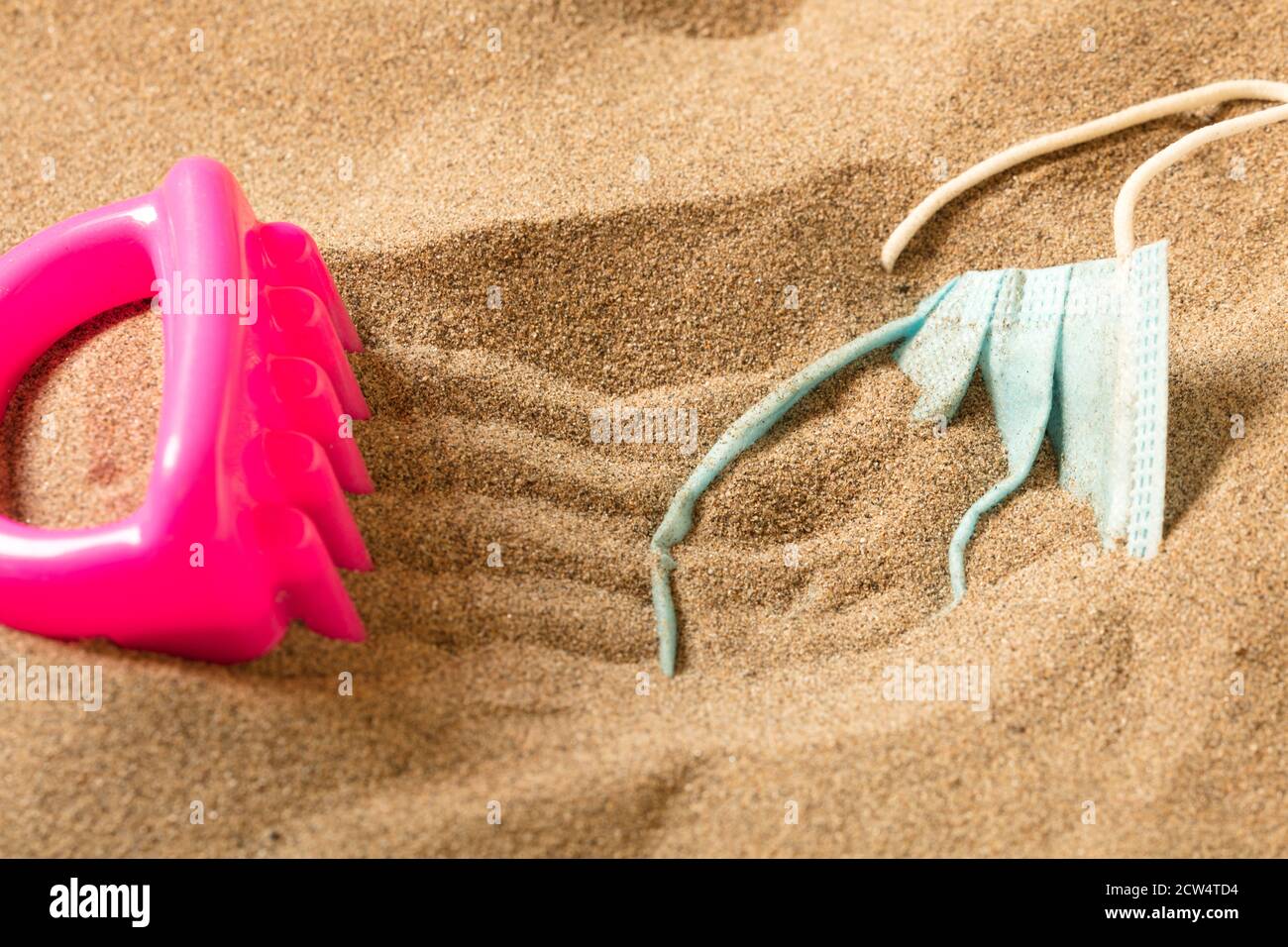 fuchsia little boy toy rake with Waste during COVID-19. Discarded to ...