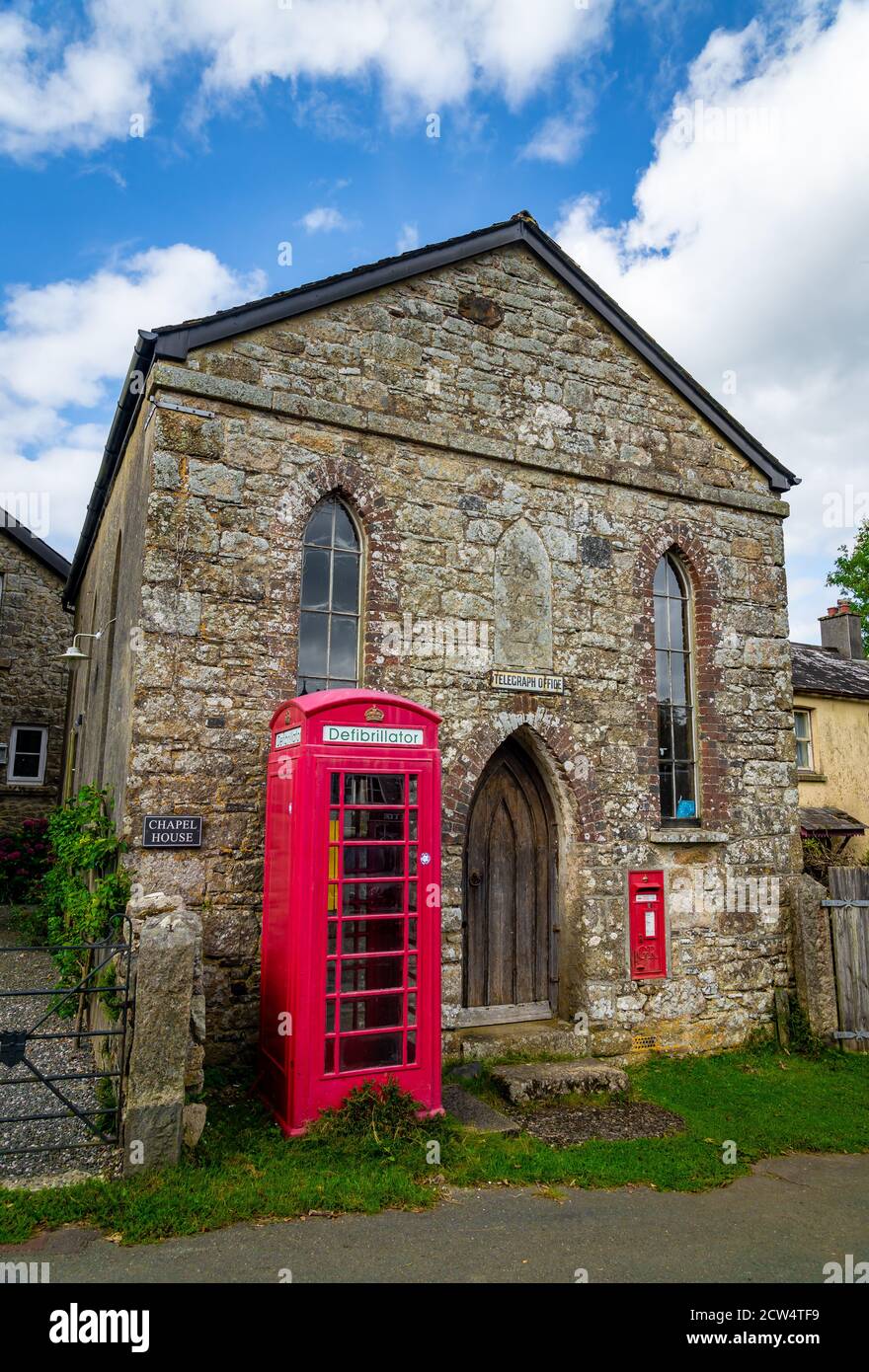 Previous chapel and telegraph building with post box and telephone kiosk in small Dartmoor village Stock Photo