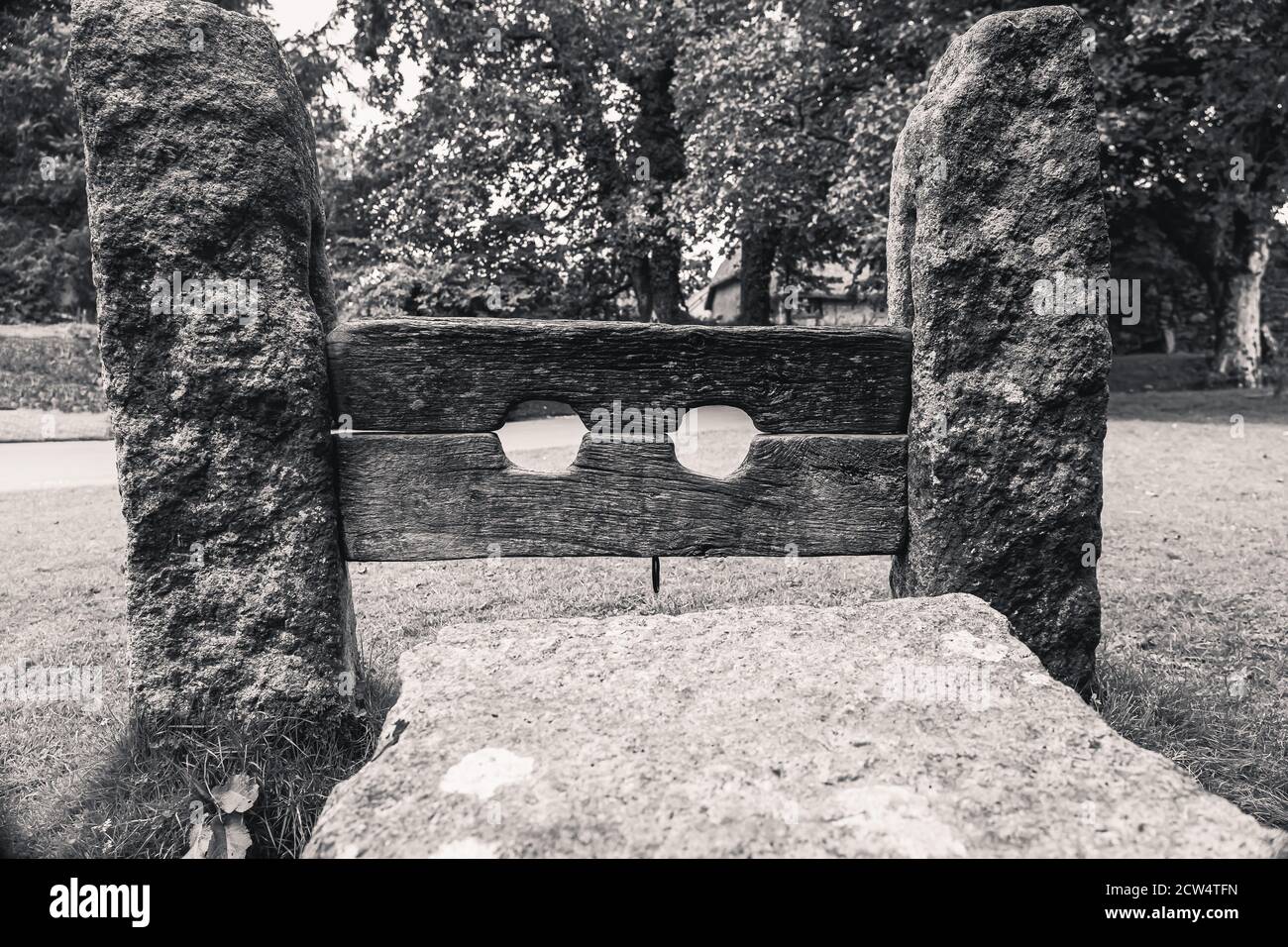 Village punishment granite and wooden stocks Stock Photo