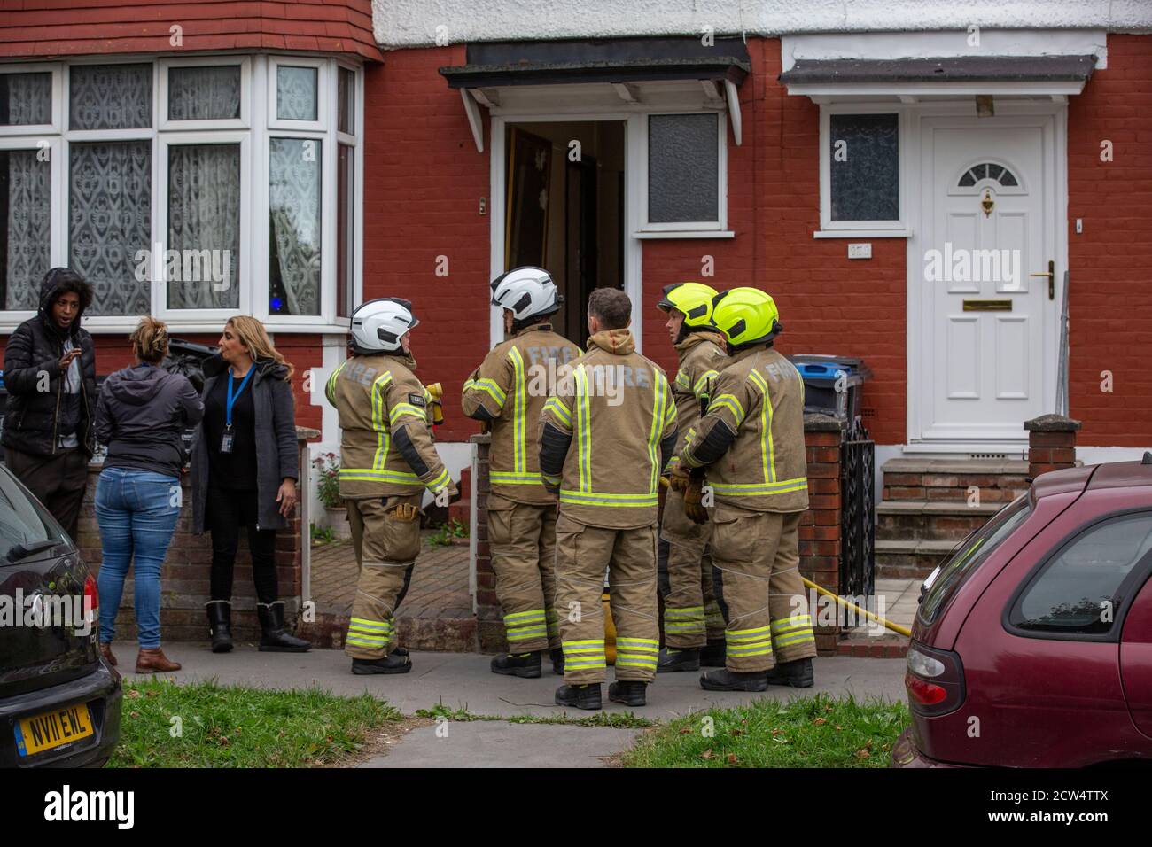 London Fire Brigade attend a house fire in a residential street in Croydon, South London, England, United Kingdom Stock Photo