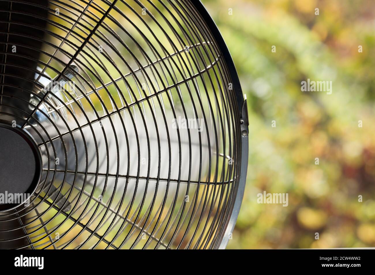 retro metal fan, with green trees background Stock Photo Alamy