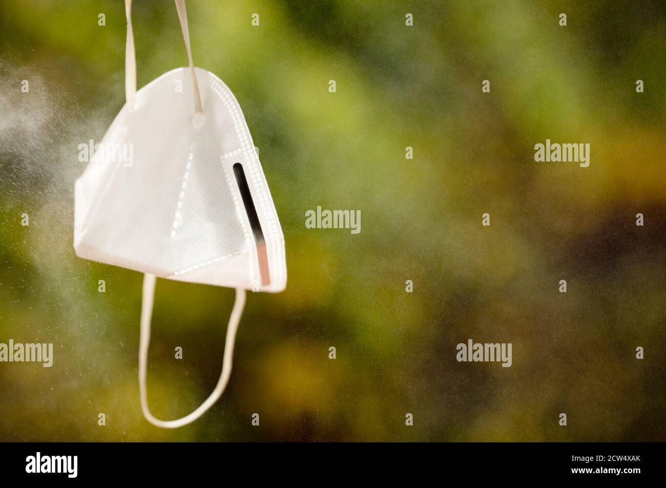 Sprayed Background Mask sprayer spray on mask protection green background of trees Stock Photo ...