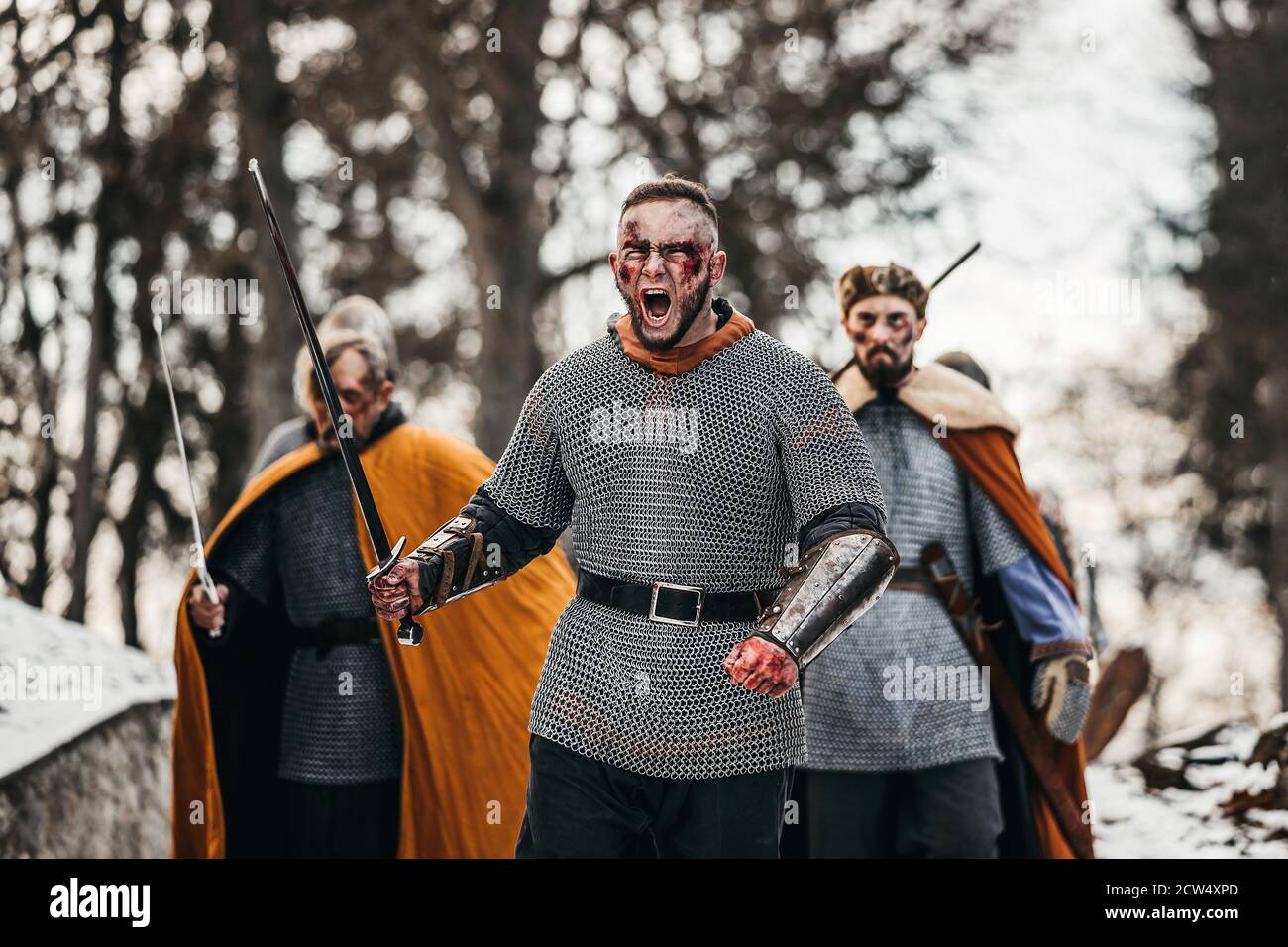 Photo of knights in armor with swords during the war. Evil emotions of ...