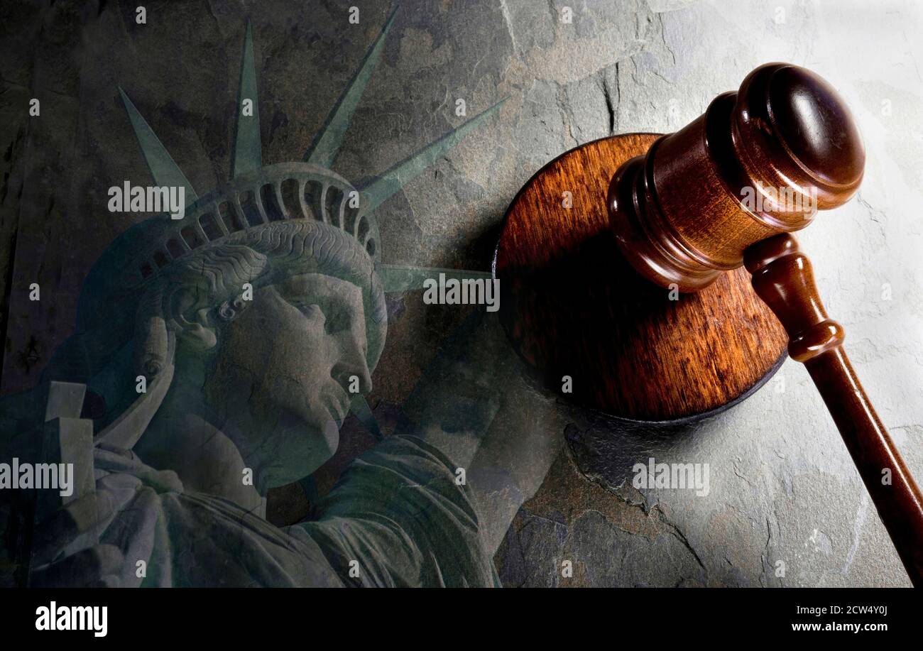 Justice and a  wooden gavel with Statue of Liberty. Stock Photo
