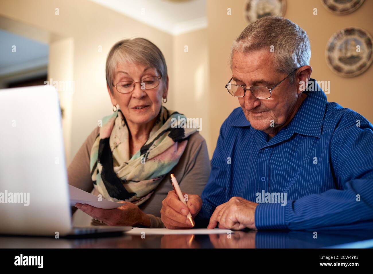 Senior Couple At Home Checking Personal Finances On Laptop Stock Photo