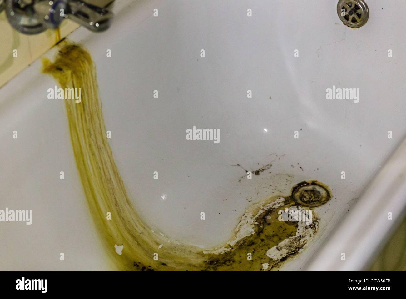 sewage from an old faucet into a clogged tub Stock Photo Alamy