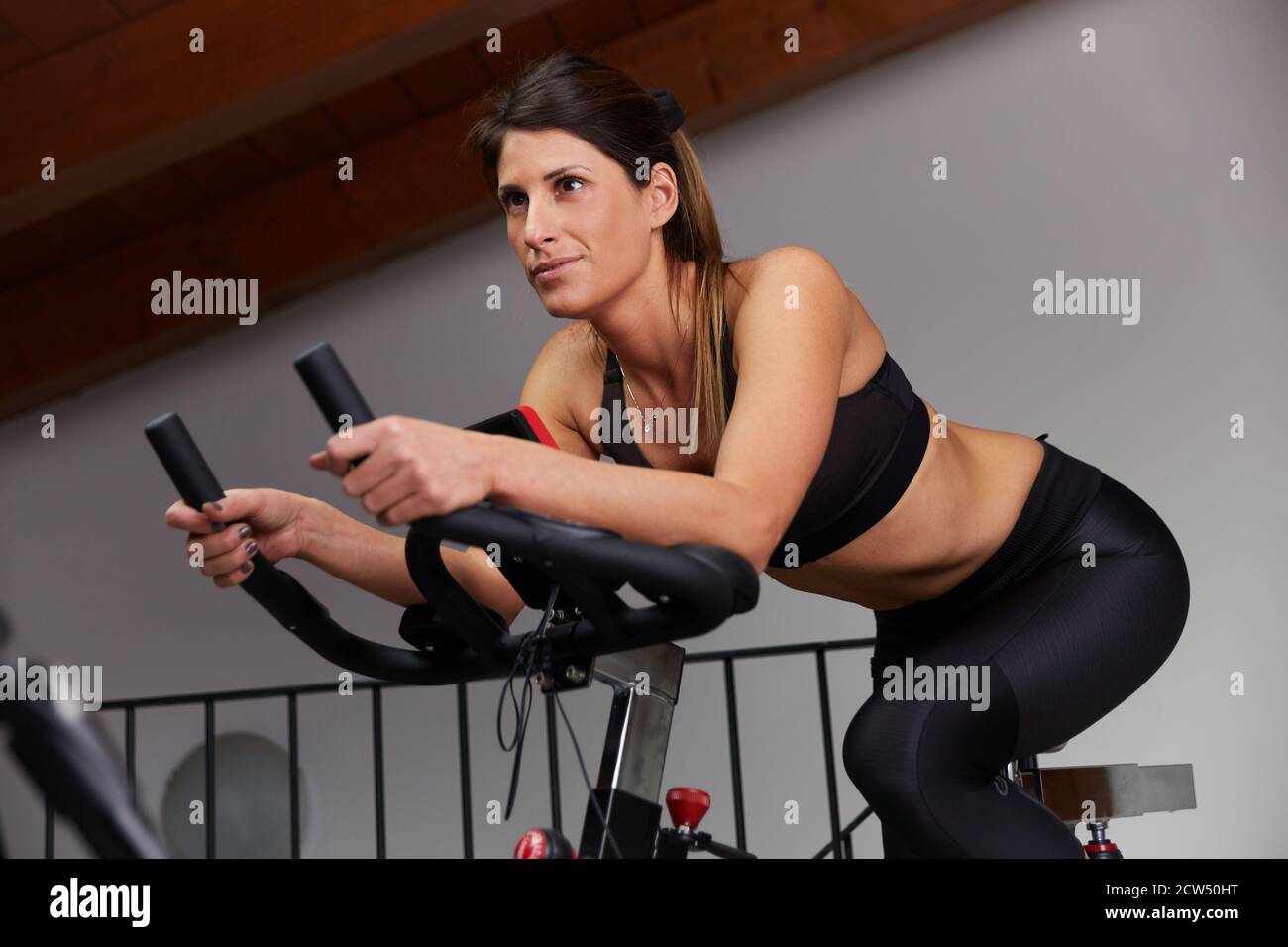 woman spinning at home exercising for their legs and cardio training