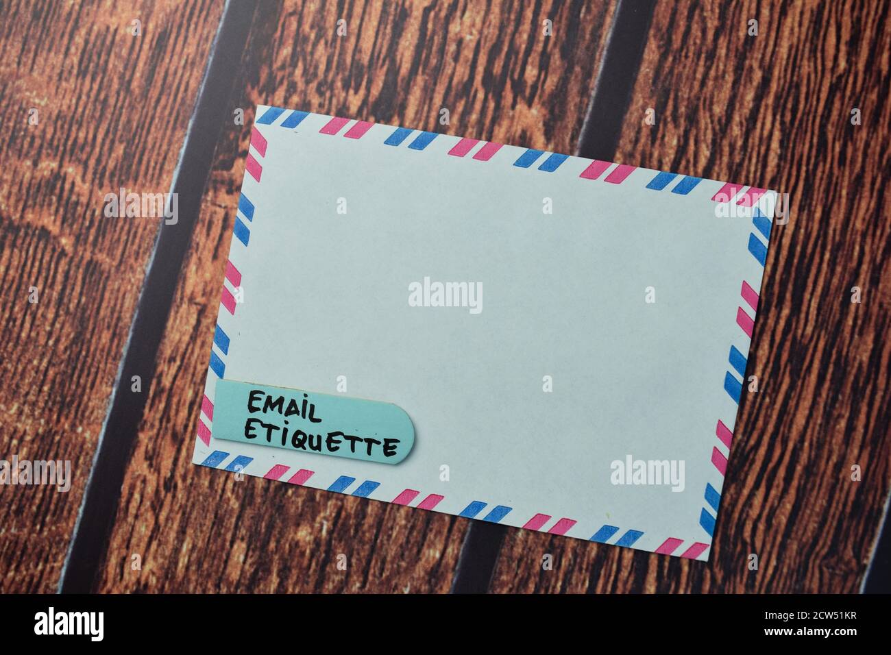 Email Etiquette write on a white envelope isolated on office desk. Stock Photo