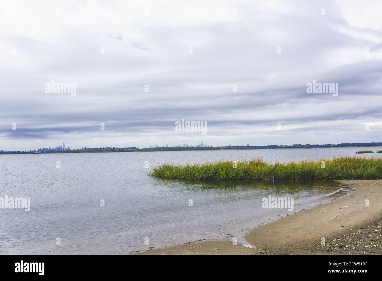 bay with sand and grass at Jamaica bay wildlife refuge with nyc background Stock Photo