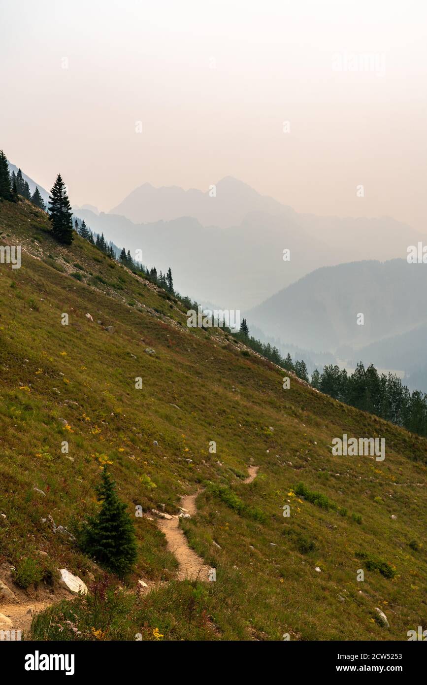 View of the Four Pass Loop hiking and backpacking trail in Colorado during the summer with hazy background from forest fires. Stock Photo