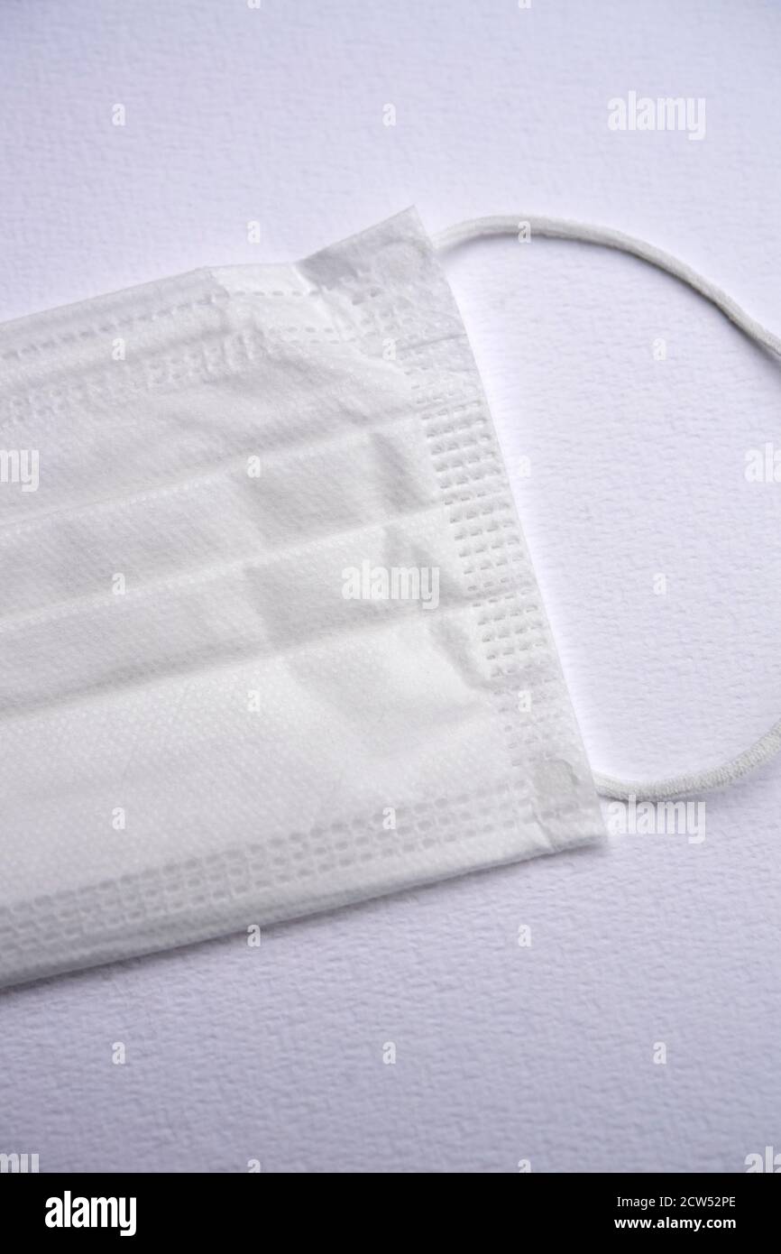 White protective face mask isolated on a white background Stock Photo