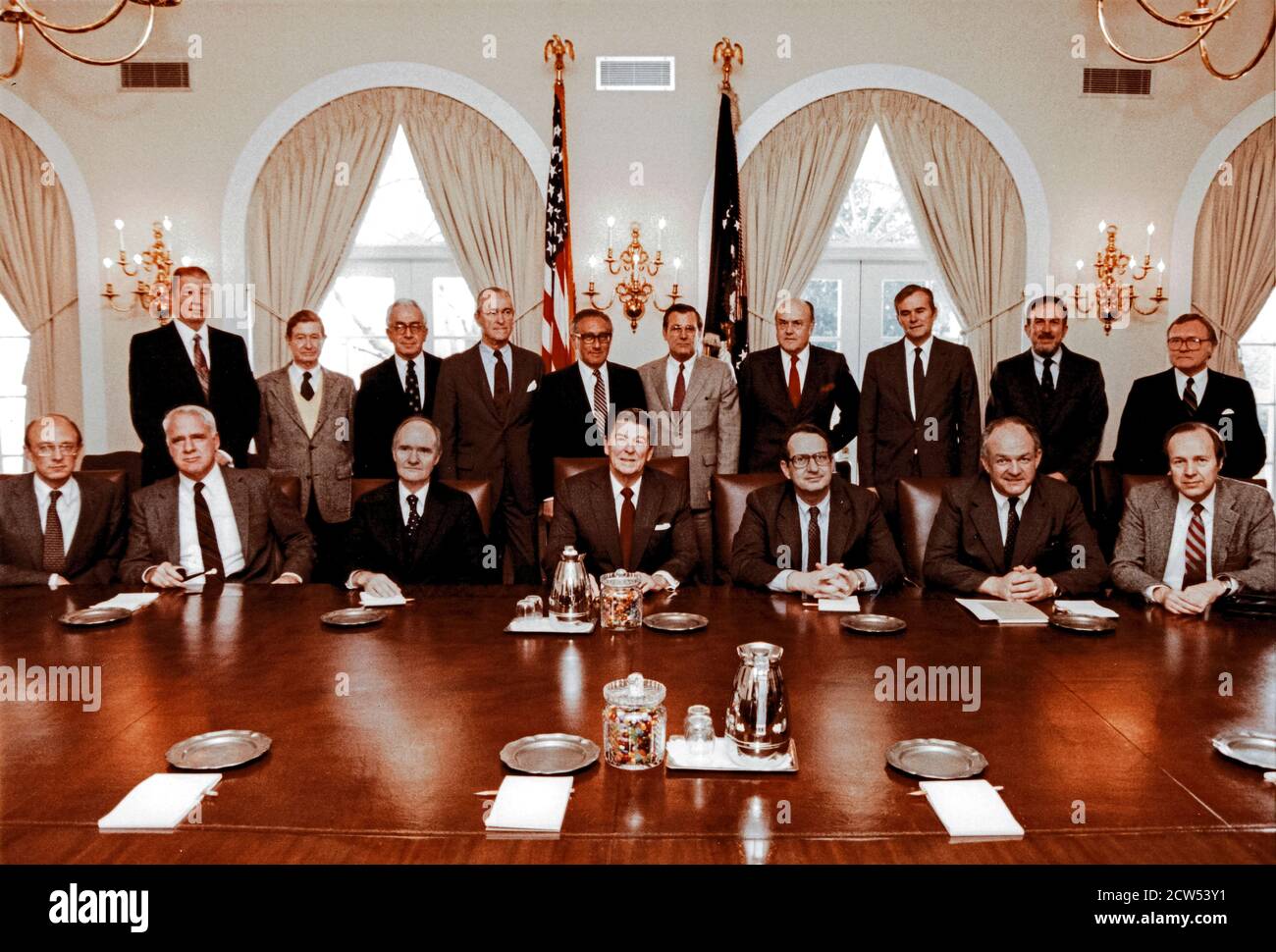 In this photo released by the White House, United States President Ronald Reagan poses with the President's Commission on Strategic Forces and the Special Counselors to the commission in in the Cabinet Room of the White House in Washington, DC on February 9, 1983. Seated in the front row: James Woolsey; Dr. James Schlesinger; Brent Scowcroft, Chairman; President Reagan; Dr. John Deutsch; Thomas Reed; Dr. William Perry. Standing in the back row, from left to right are: John Lyons; Vice Admiral Levering Smith, US Navy (Retired); Lloyd Cutler; Richard Helms; Dr. Henry Kissinger; Donald Rumsfeld Stock Photo