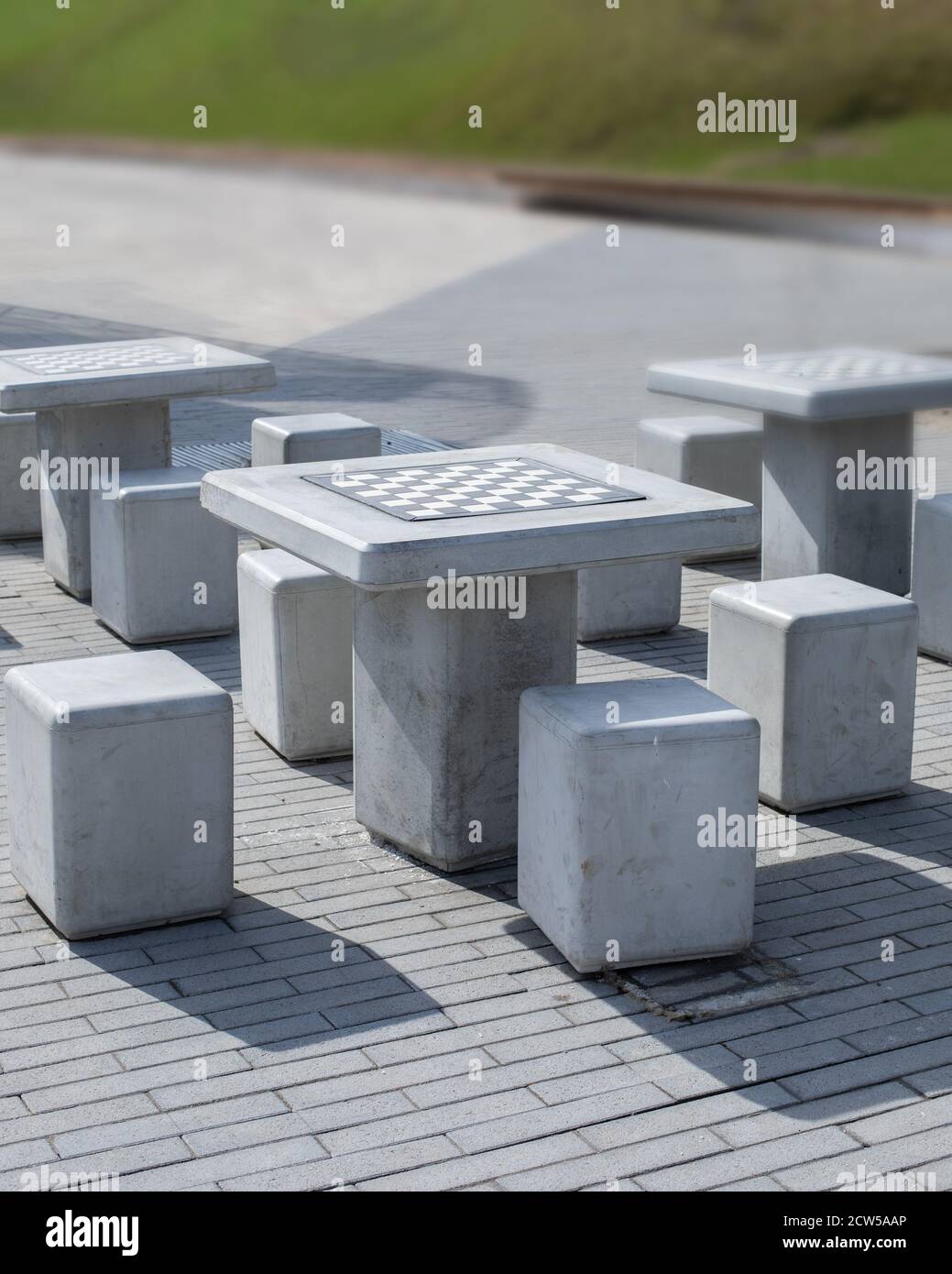 Chess table checkerboard in the park. Chessboard table and chairs in ...