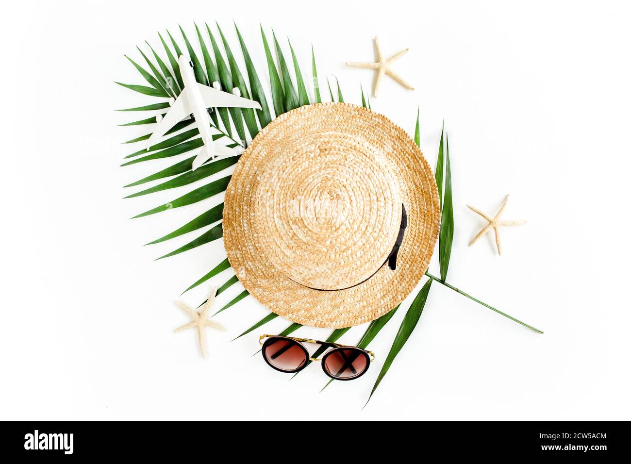 Traveler accessories concept on white background. Straw hat, model