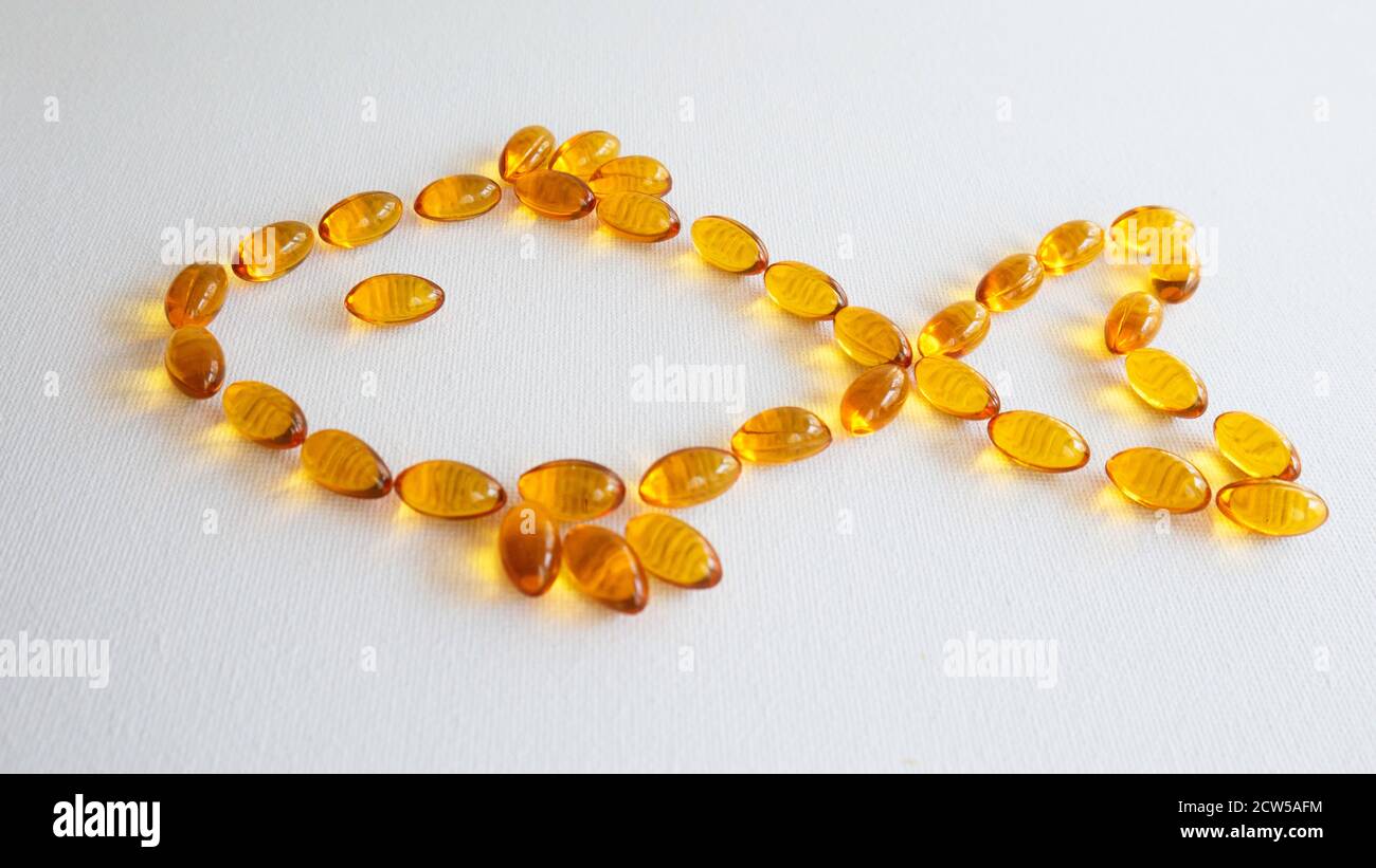 Fish oil capsules - fish shape Stock Photo - Alamy