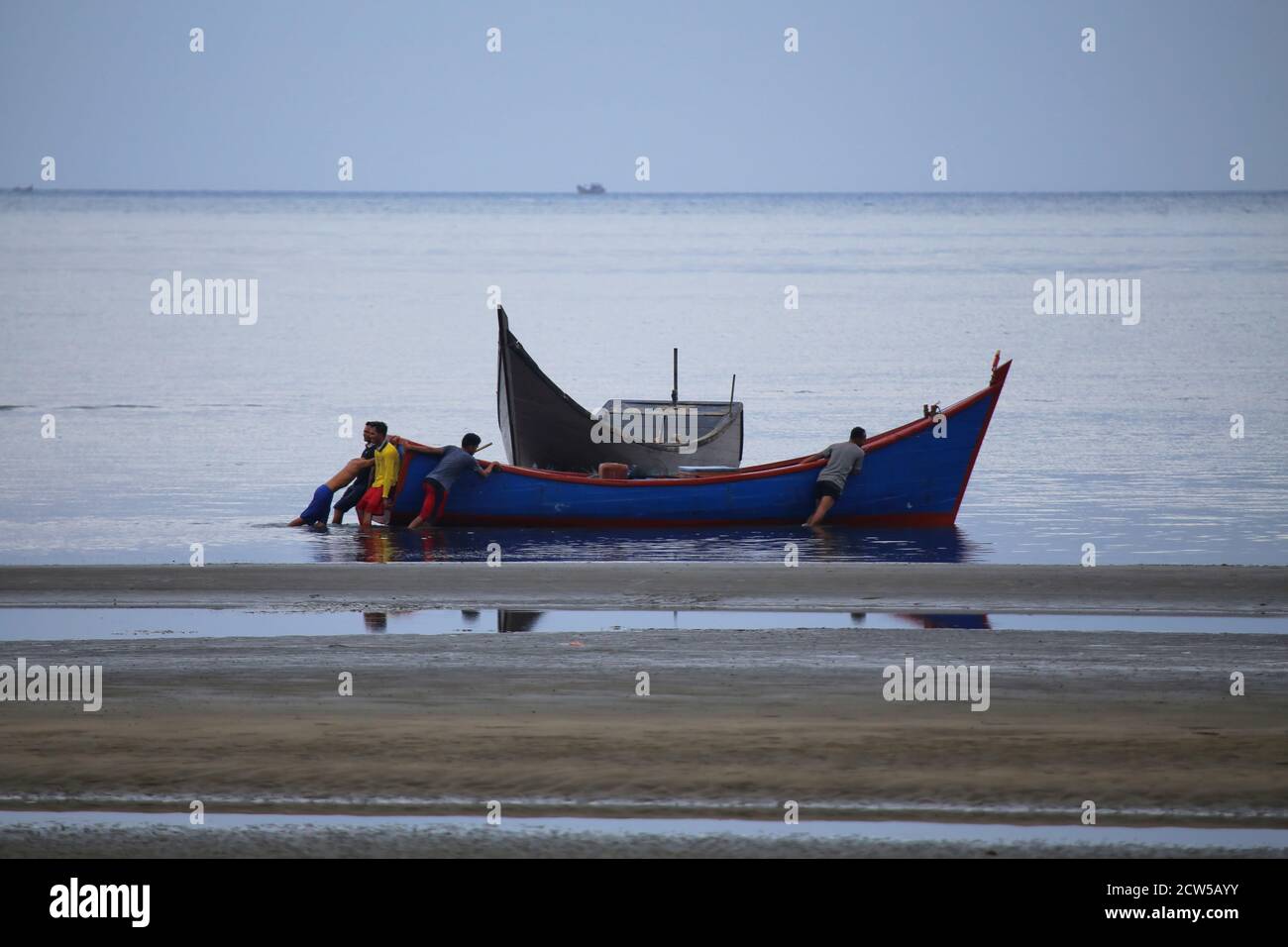 Residents of Banda Aceh, Indonesia, who live on the coast, are working to make a living on tidal beaches, during the COVID-19 pandemic Stock Photo