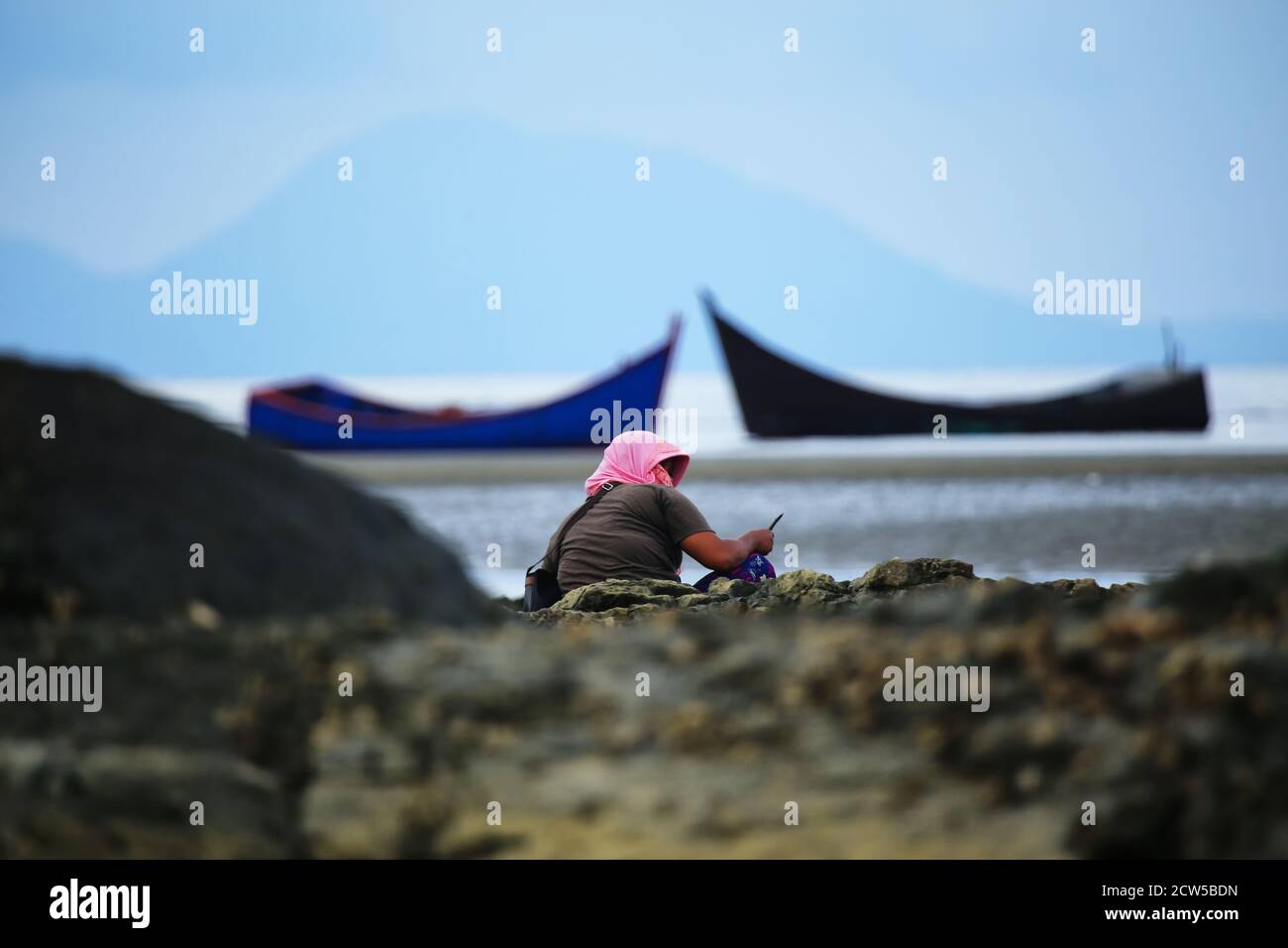 Residents of Banda Aceh, Indonesia, who live on the coast, are working to make a living on tidal beaches, during the COVID-19 pandemic Stock Photo