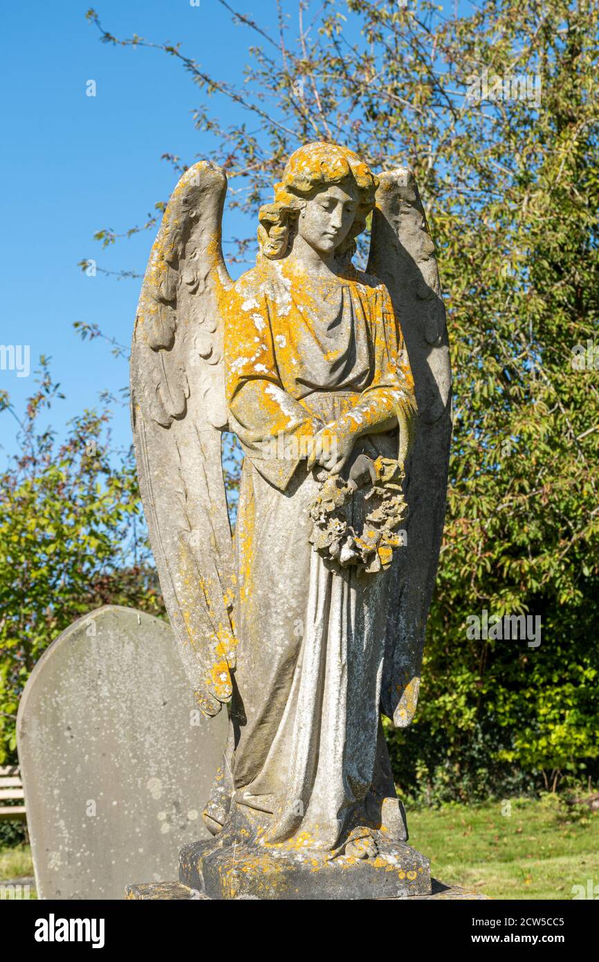 A stone angel statue in a churchyard Stock Photo