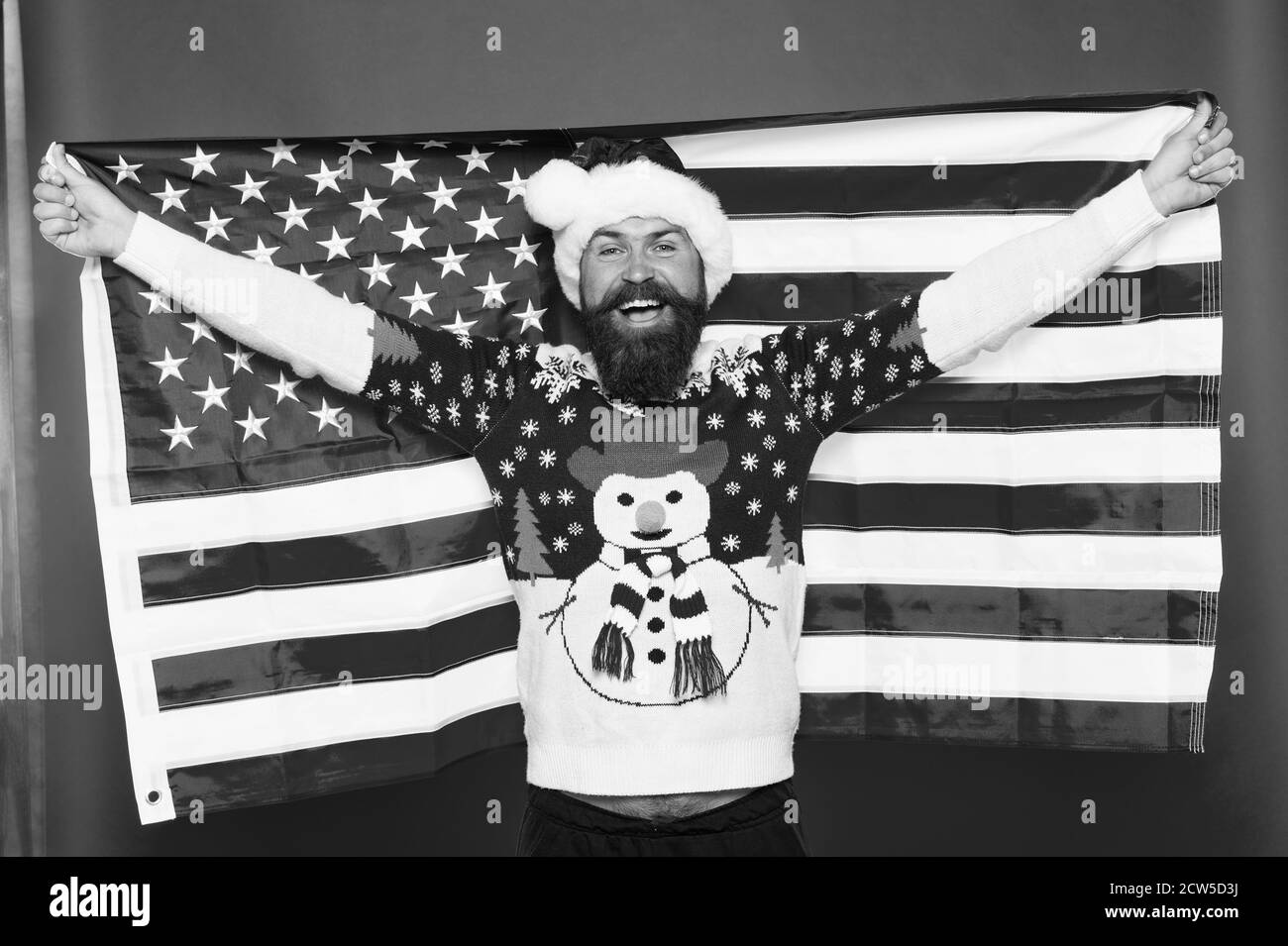 Merry american xmas. Happy Santa hold american flag. Bearded man celebrate xmas. Holiday decoration and decor. All american xmas party. Happy new year. Its xmas time. Stock Photo