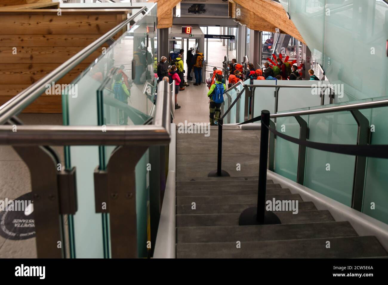 High-angle view of the interior of Pointe Helbronner station of Skyway Monte Bianco with a group of backpackers waiting for a cabin, Courmayeur, Italy Stock Photo