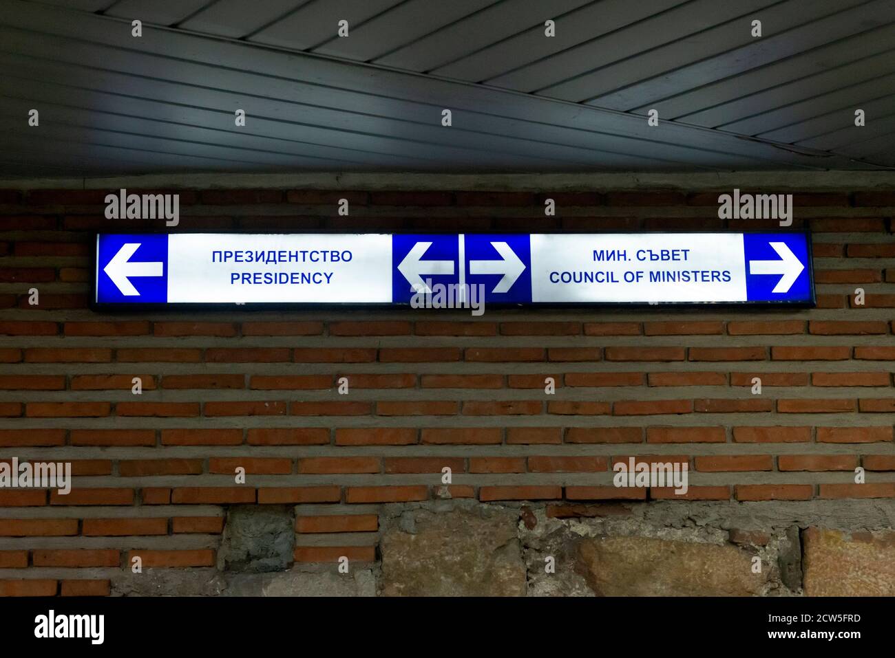 Illuminated direction signs for the Presidency and for the Council of Ministers in underground pedestrian passageway near the National Assembly of the Republic of Bulgaria in Sofia Bulgaria Stock Photo