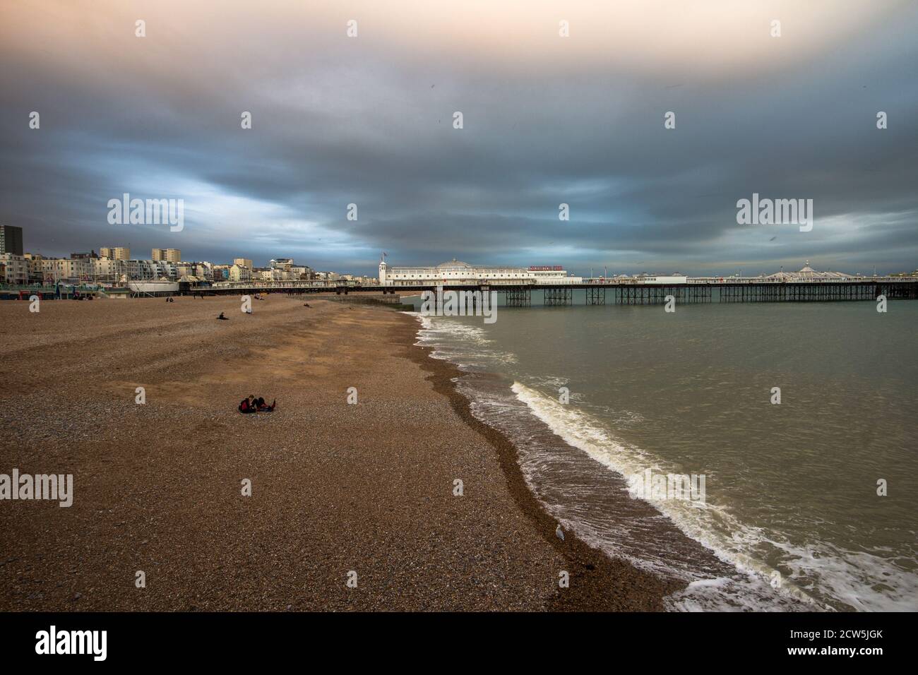 Brighton, East Sussex, England, UK. 27 Sunset on Brighton beach looking towards the pier, deserted beach despite many students heading to town for the start of freshers week September 2020 ©Sarah Mott / Alamy Live News Stock Photo