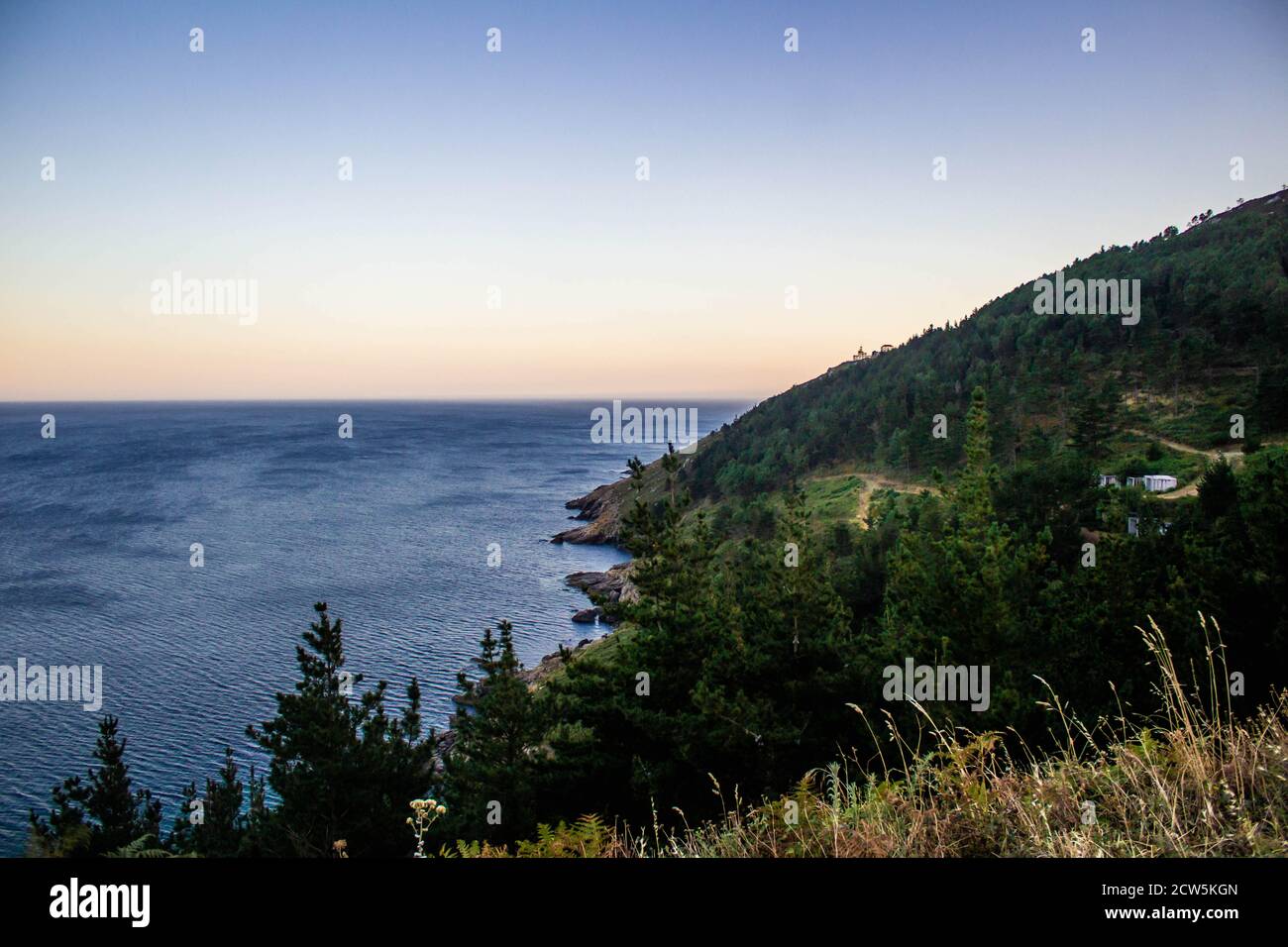 sunset in the sea of â€‹â€‹finisterre with a mountain Stock Photo