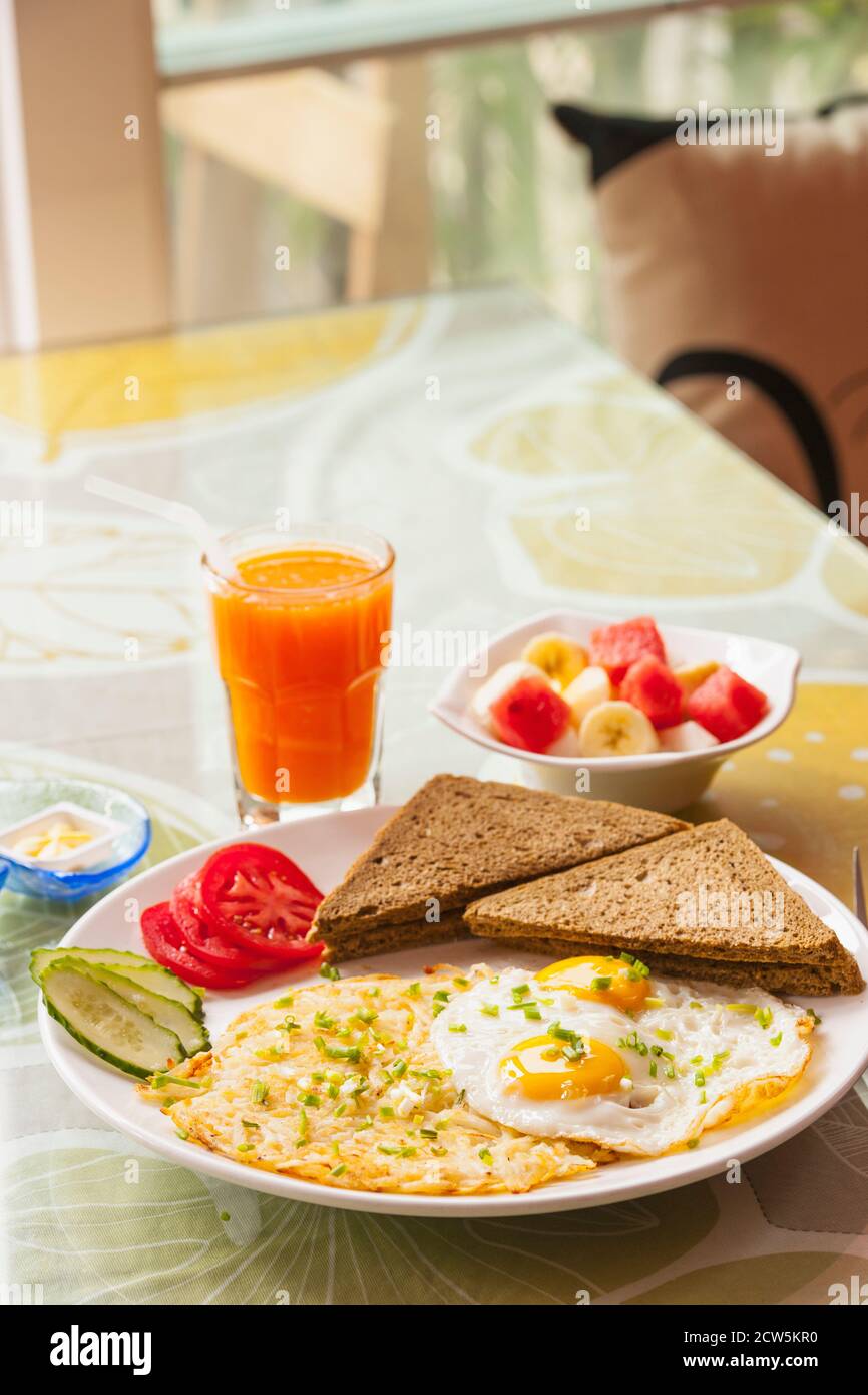 healthy breakfast with fried eggs and fruit bowl in Yangshuo Stock