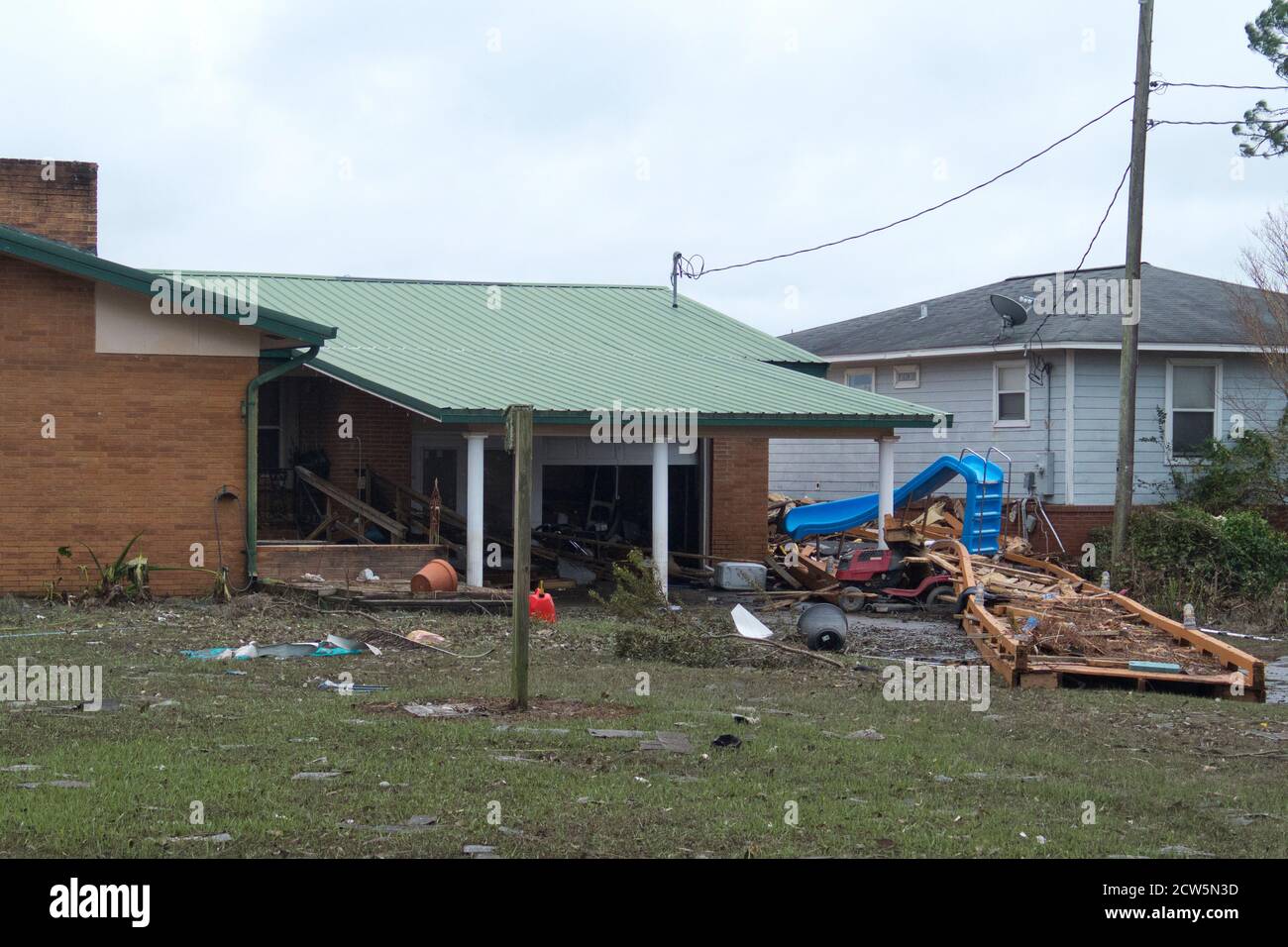 Debris from Perdido Bay deposited in the backyard of a home in the Bass Point community in south Alabama. Stock Photo