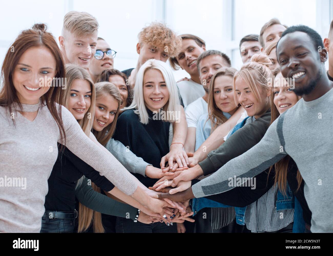 diverse young people putting their hands together Stock Photo - Alamy