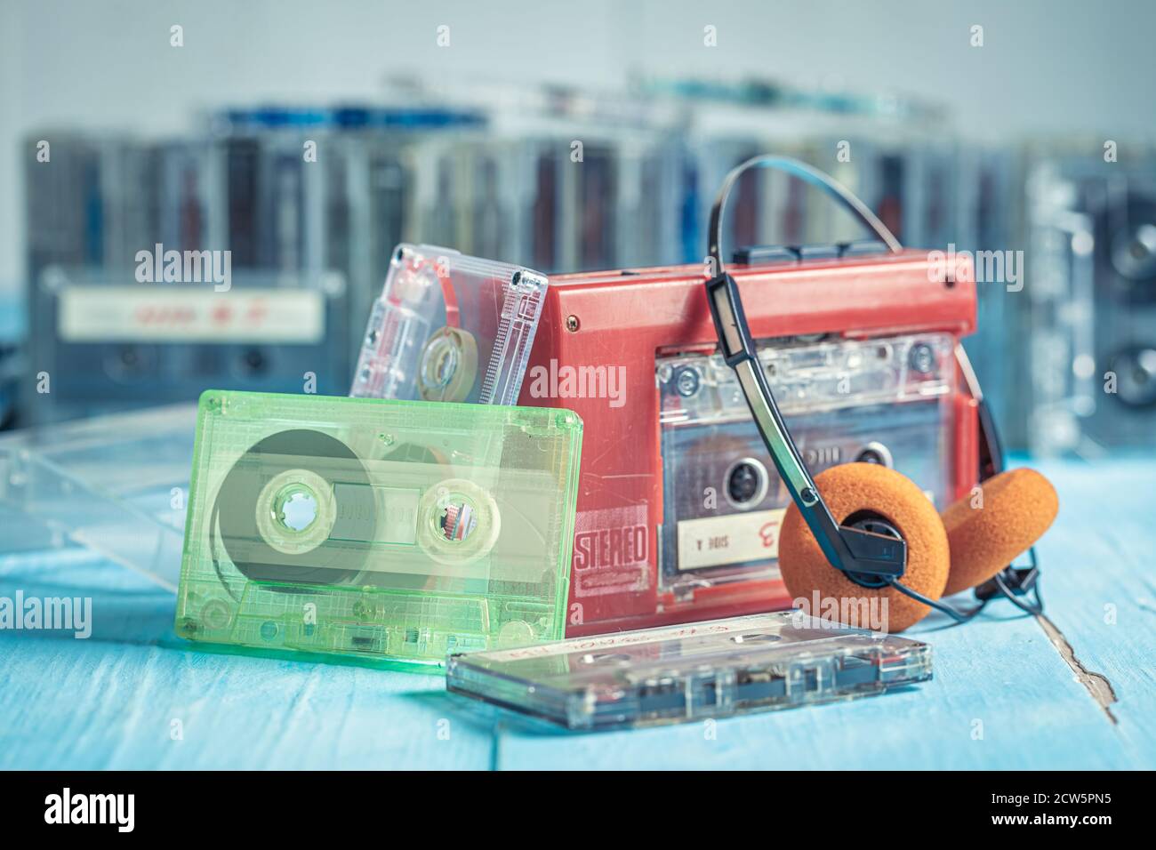 Retro cassette tape with player and headphones on blue table Stock ...