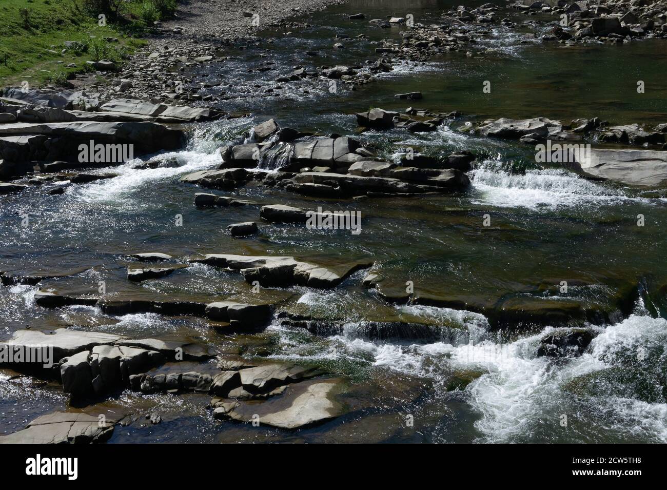 Wild mountain river. Water stream over stones. Mountain river close up. River Prut in the Carpathian Mountains in Ukraine Stock Photo