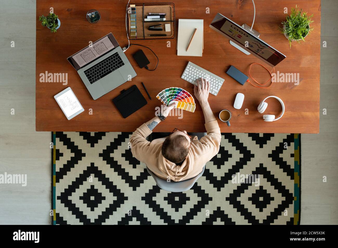 Top view of young contemporary freelance software developer making logo Stock Photo