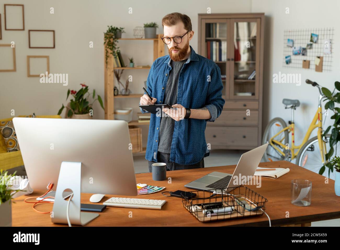 Young creative software developer or designer drawing on tablet display Stock Photo