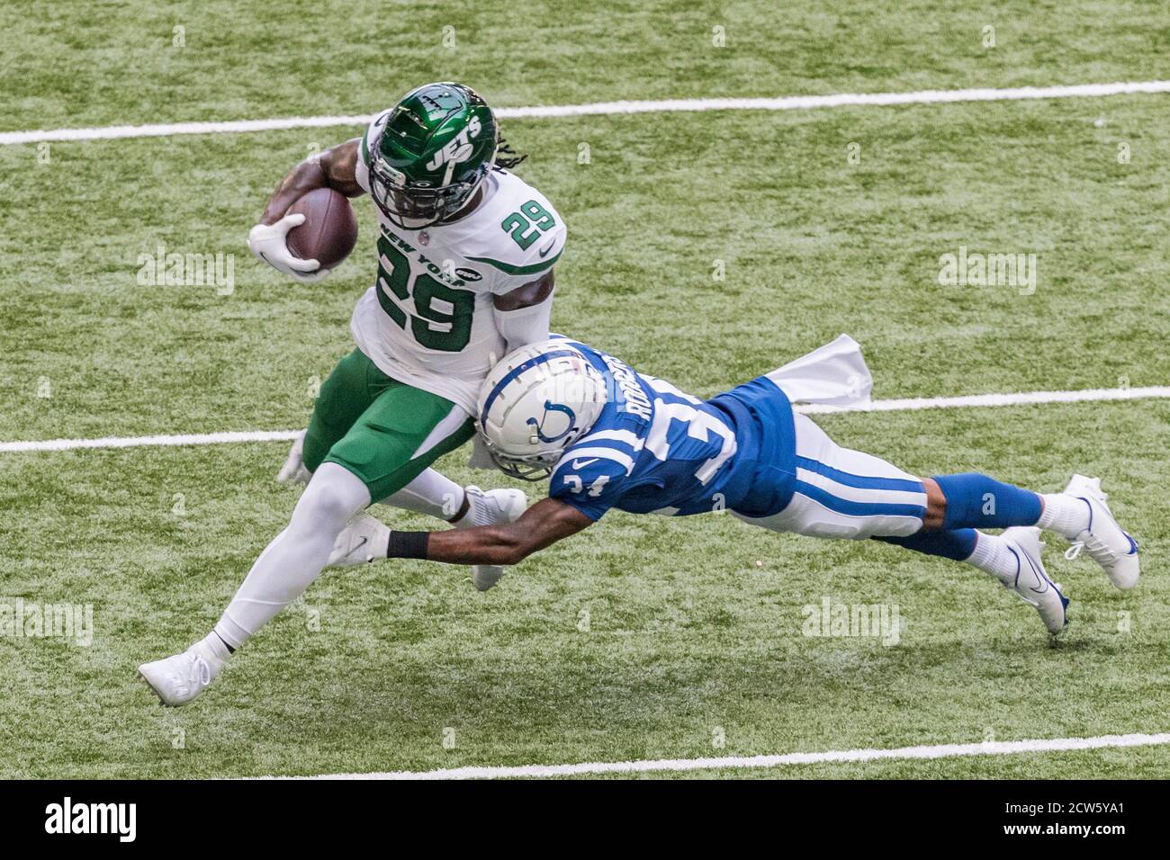 Indianapolis, Indiana, USA. 27th Sep, 2020. New York Jets running back Kalen Ballage (29) is tackled by Indianapolis Colts cornerback Isaiah Rodgers (34) during the game between the New York Jets and the Indianapolis Colts at Lucas Oil Stadium, Indianapolis, Indiana. Credit: Scott Stuart/ZUMA Wire/Alamy Live News Stock Photo