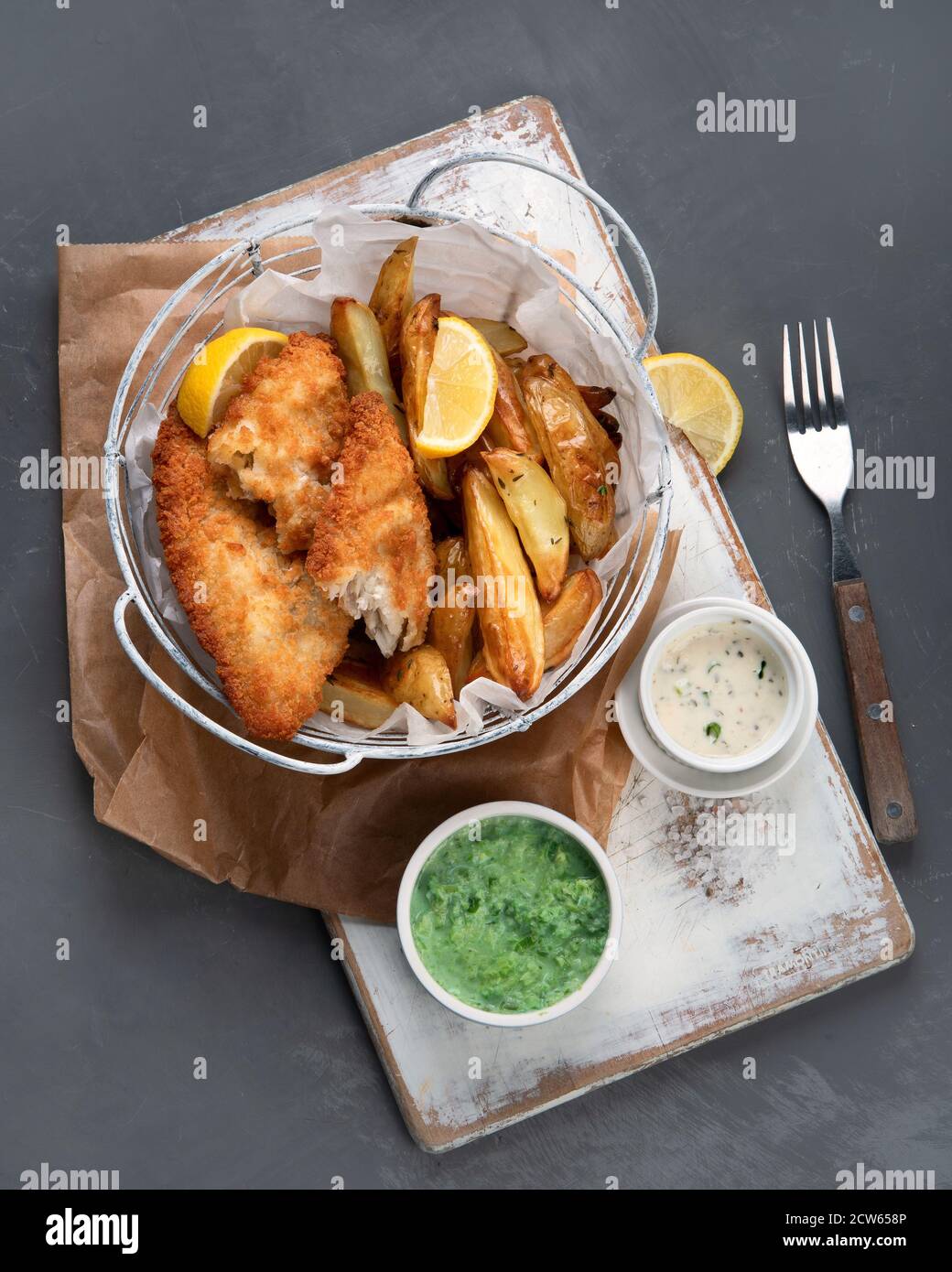 Uk Cooking British traditional cuisine fish and chips. Served with mashed peas and ...