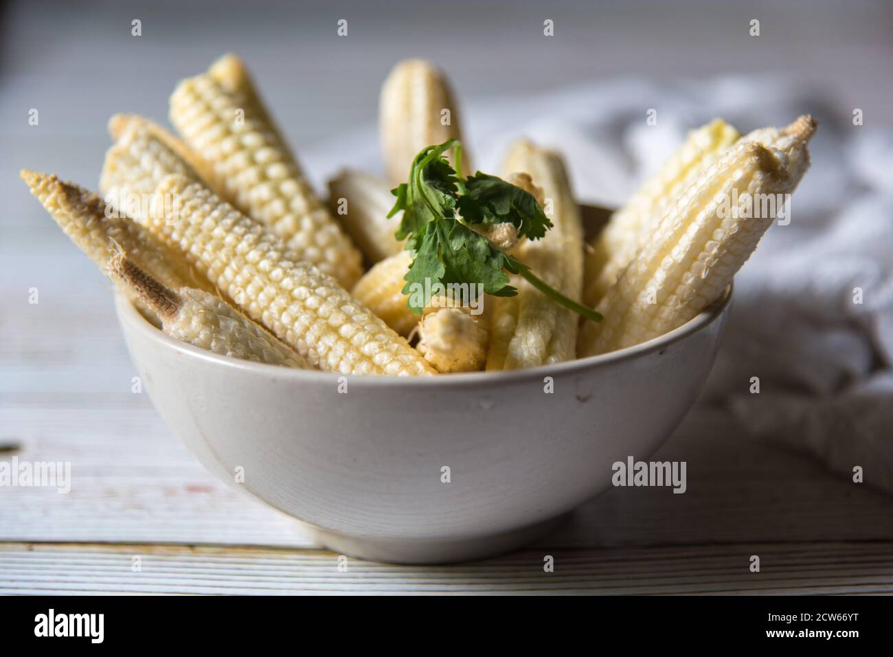 Close up of fresh baby corns in a bowl Stock Photo