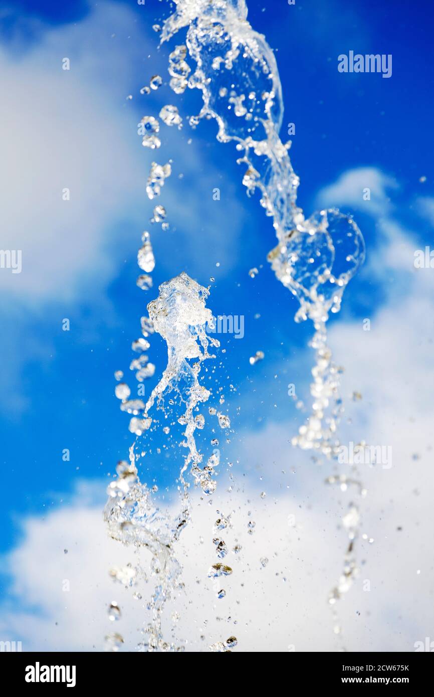 water drops from the fountain against blue summer sky Stock Photo