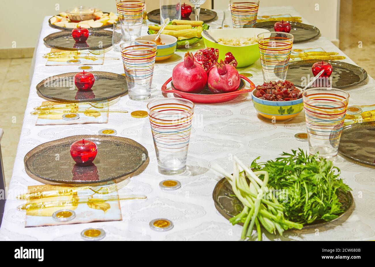 Festively decorated table for Rosh Hashanah with pomegranates and apples. Stock Photo