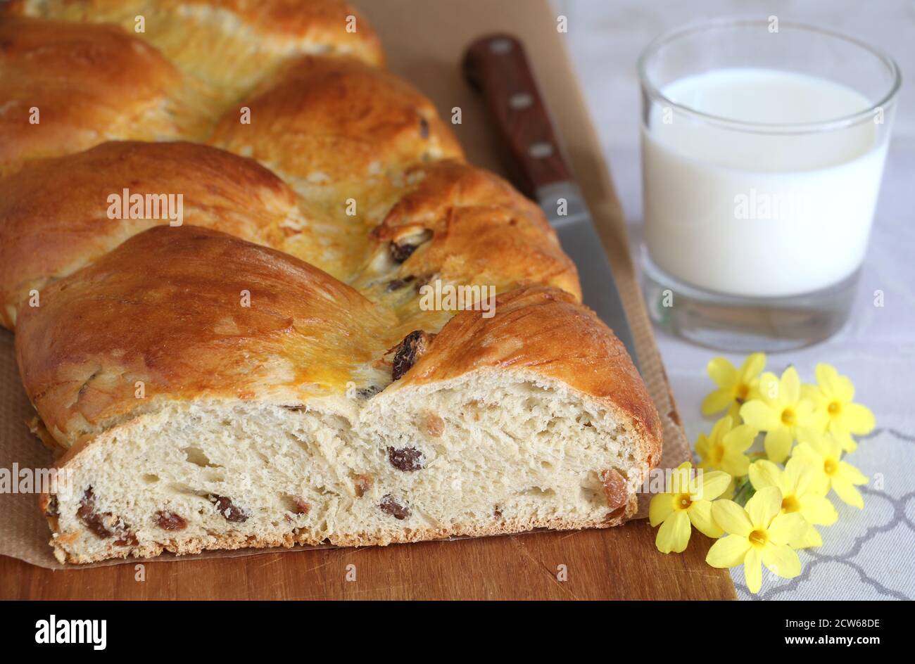 yeast plait with raisins and glass of milk Stock Photo