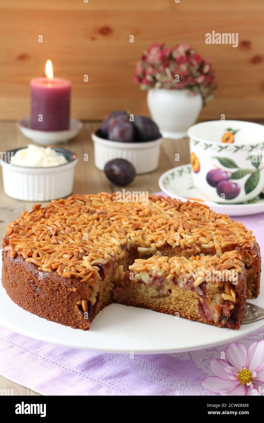 plum cake with almonds on cake plate Stock Photo