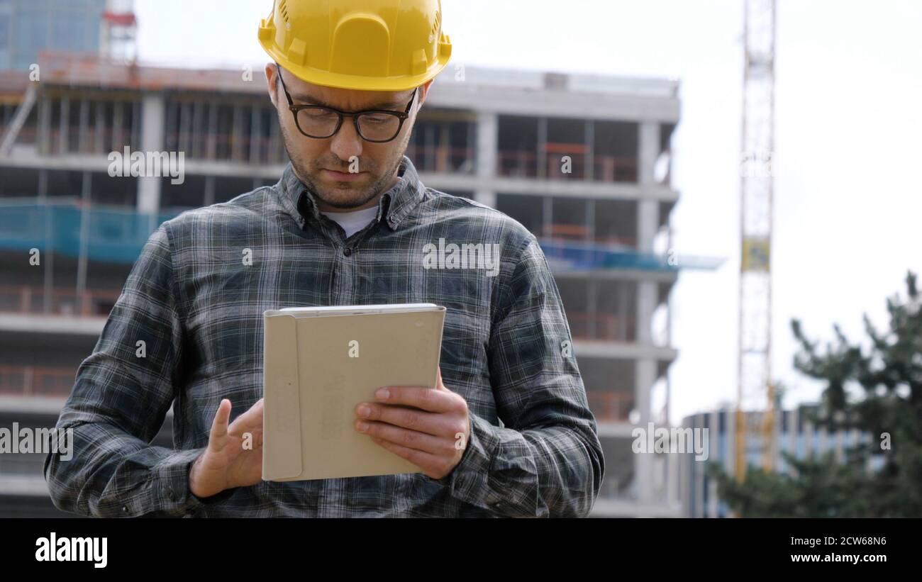 Architect On Building Site Using Digital Tablet. Stock Photo