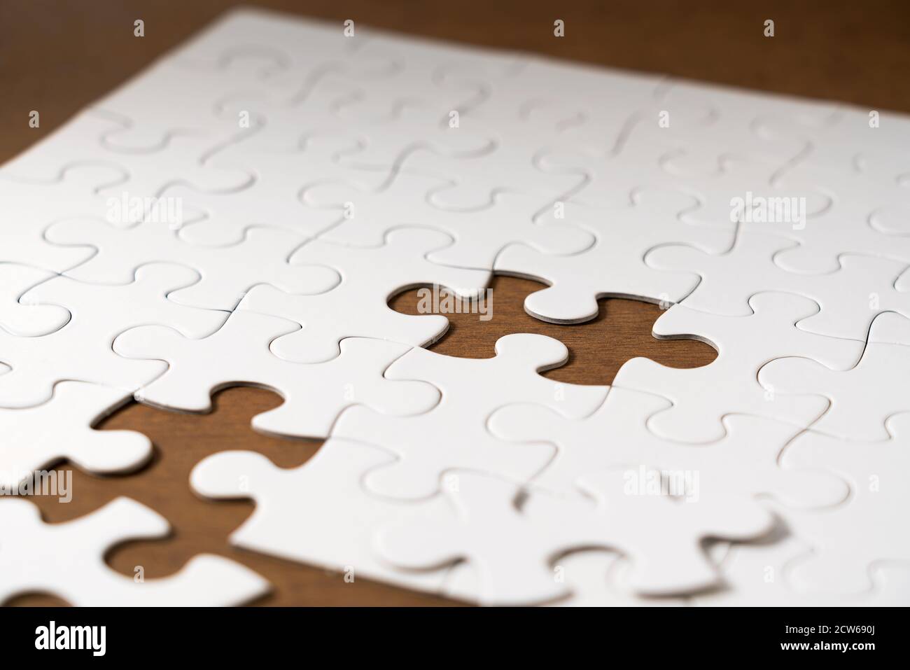 White jigsaw puzzle on the table. Stock Photo