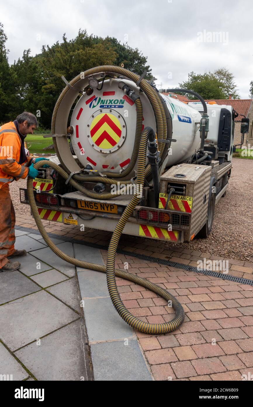 worker with pipe Sewer Vacuum Truck Stock Photo Alamy