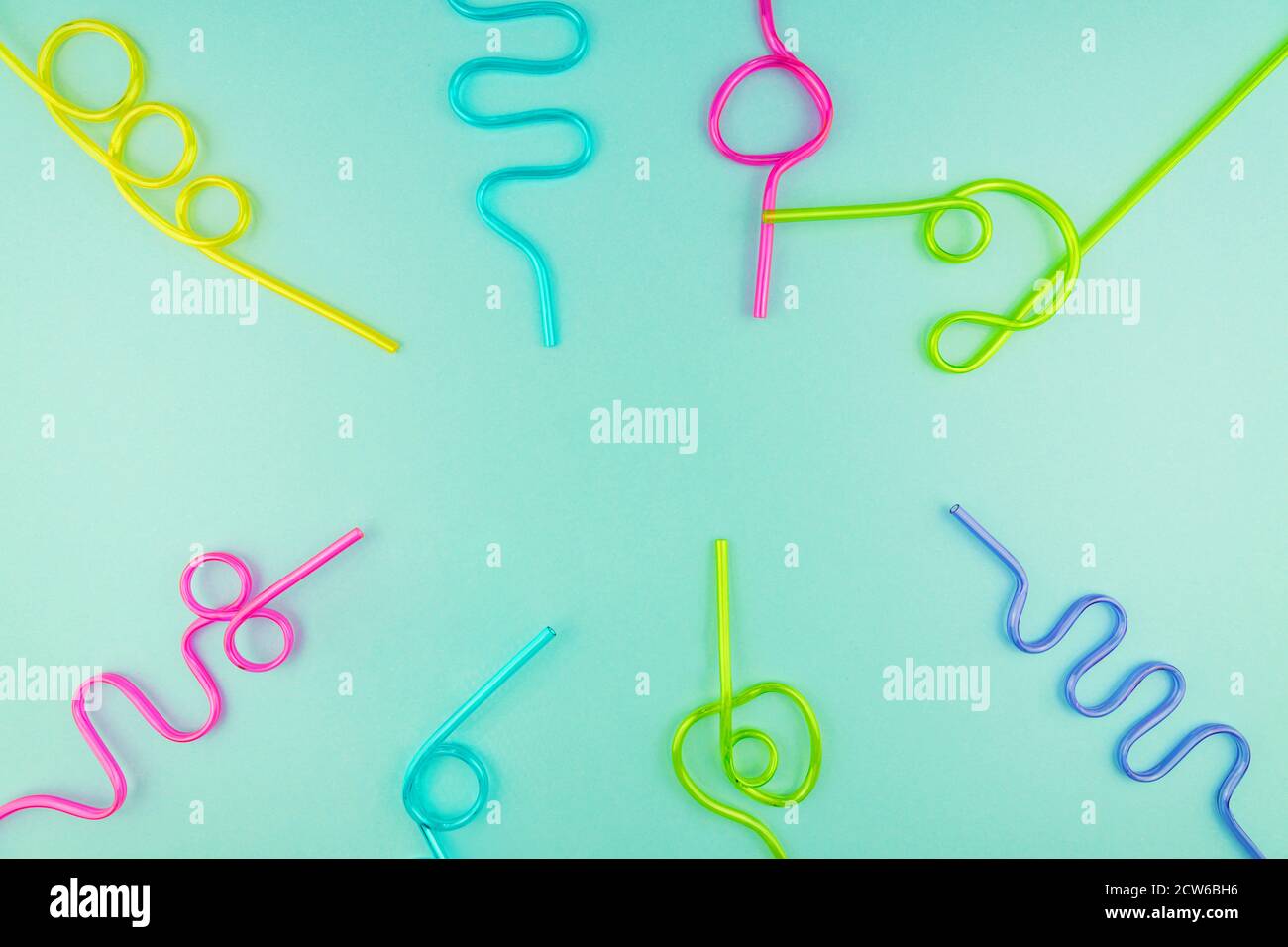 multicolored plastic cocktails straws on blue background. Stock Photo