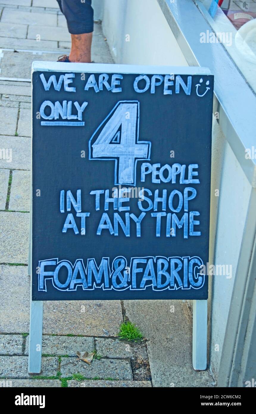 Covid-19 Pandemic Sign Notice Four in Shop Sign Seaford Sussex Stock Photo
