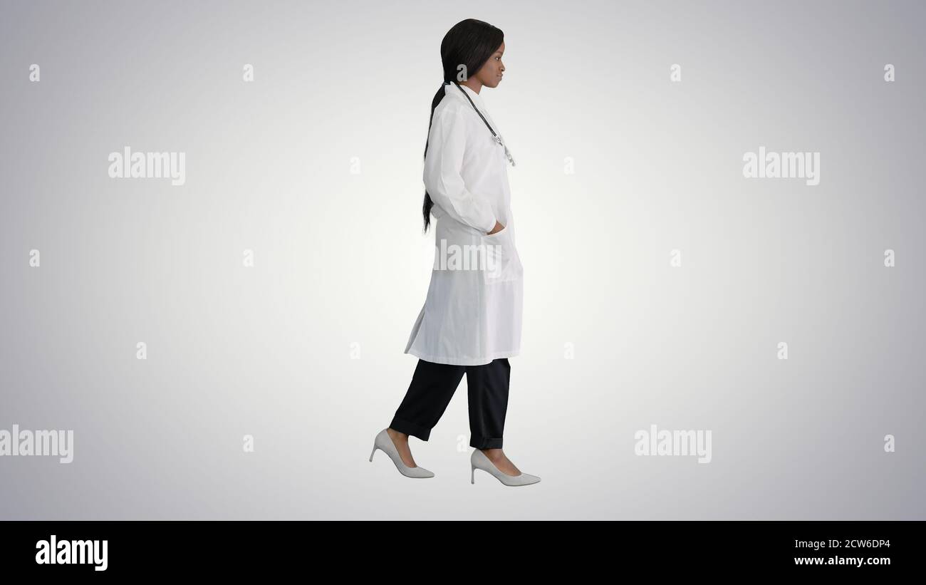 Sad African american female doctor walking with hands in her poc Stock Photo
