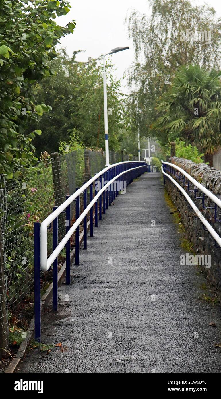The pedestrian slope at Appley Bridge on a wet morning in Greater Manchester. The station is on