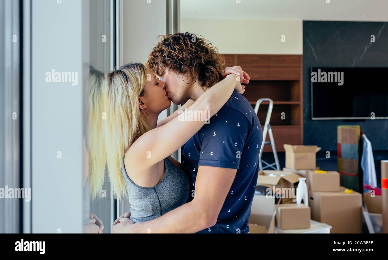 Couple kissing in the living room Stock Photo