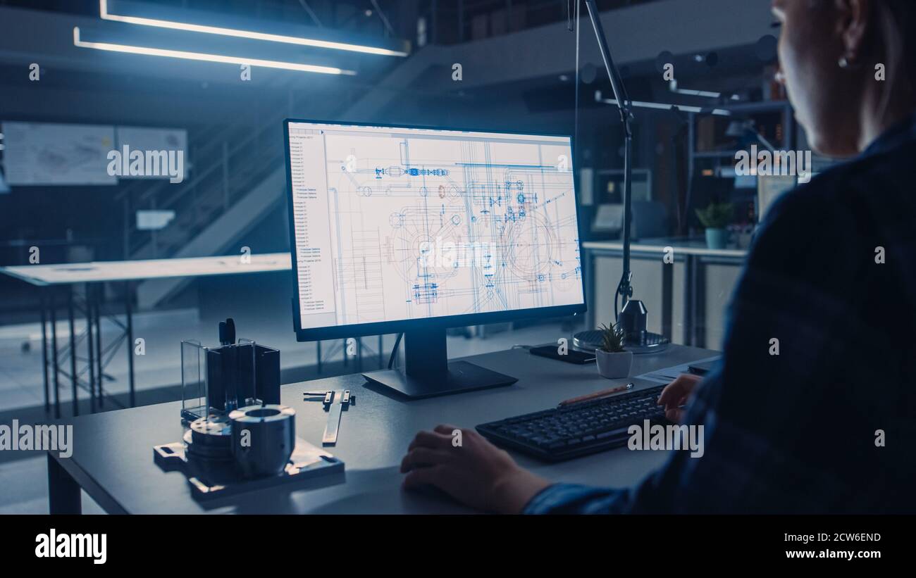 Engineer Working on Desktop Computer, Screen Showing CAD Software with ...